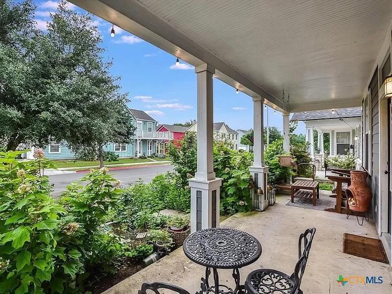 An inviting covered porch overlooks a charming st