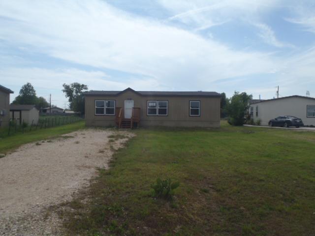 A quaint mobile home features a welcoming front p