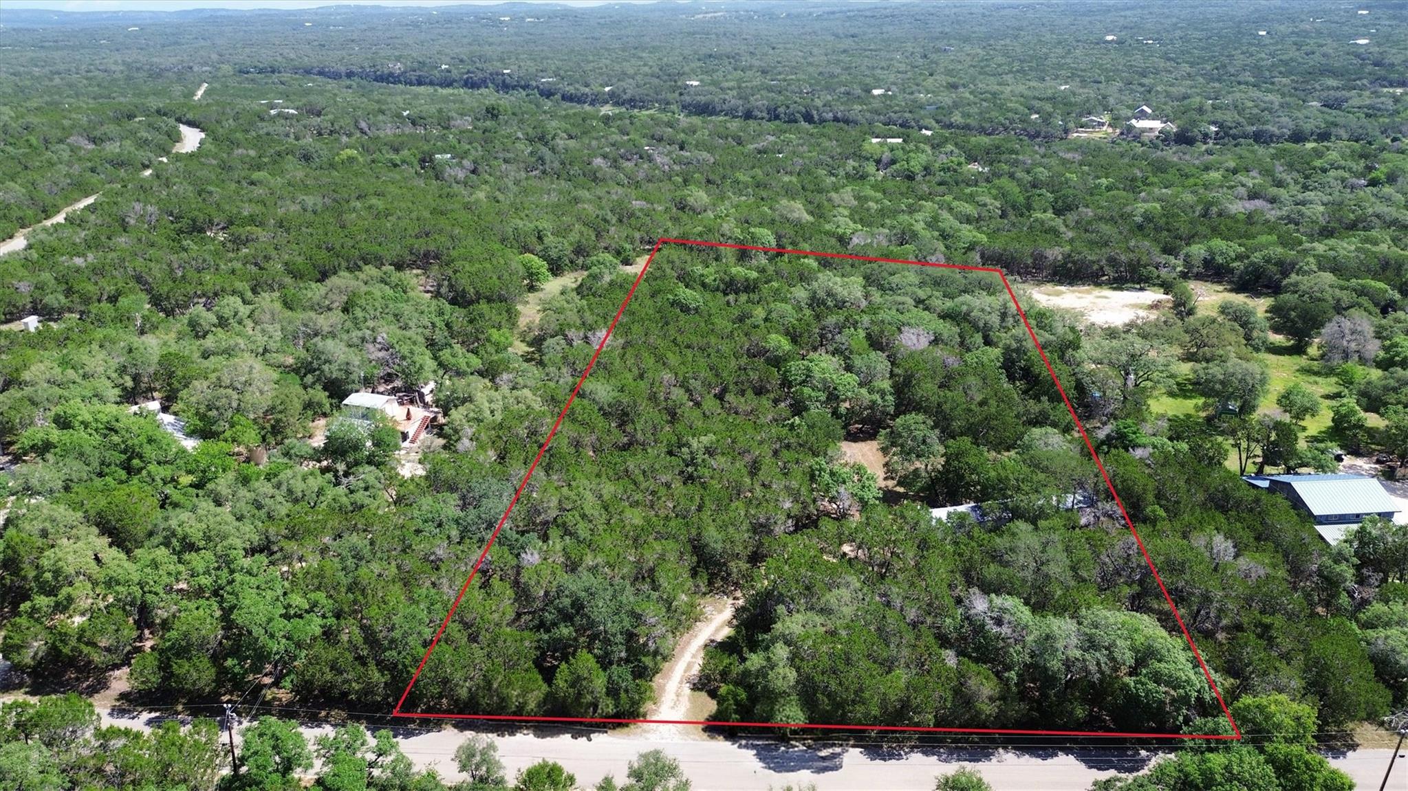 Mature trees blanket this expansive parcel, offer