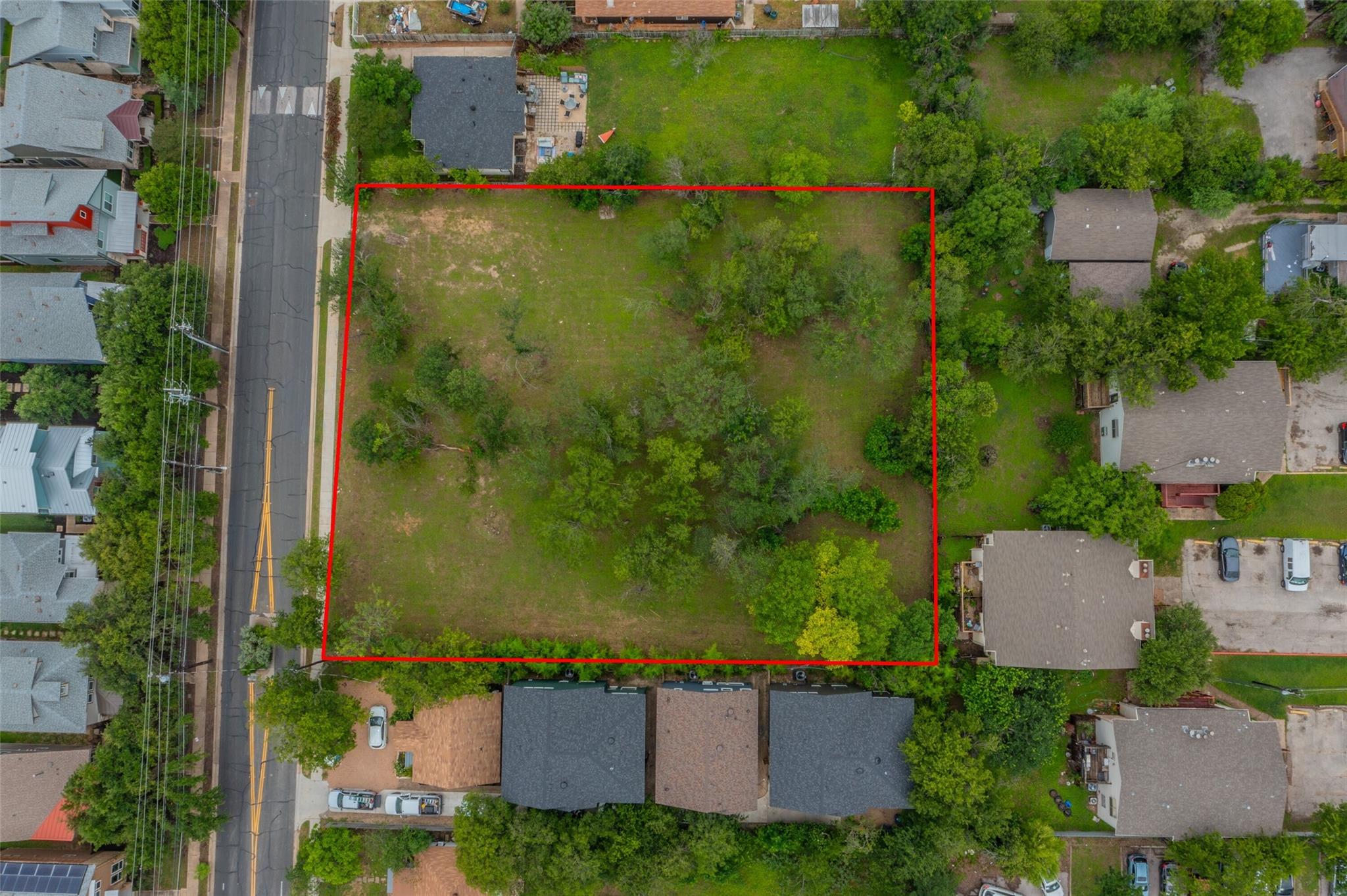 A spacious, verdant lot awaits your vision, borde
