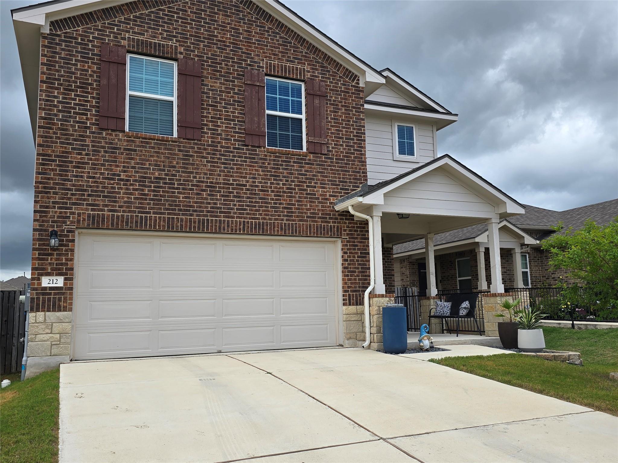 A classic brick and siding residence, complete wi