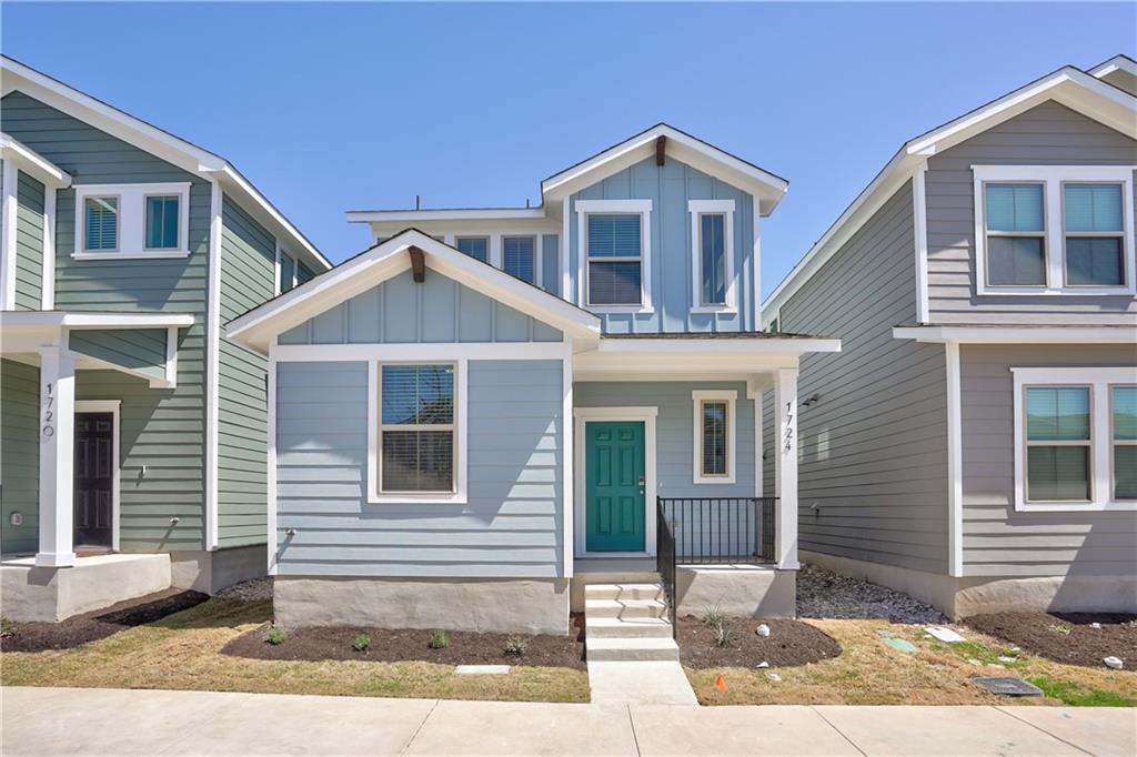 A charming light blue residence with white trim a