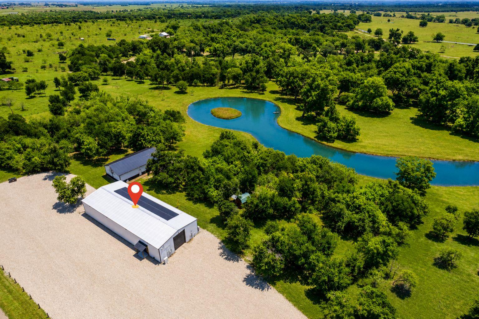 Discover vast green landscapes with a serene pond