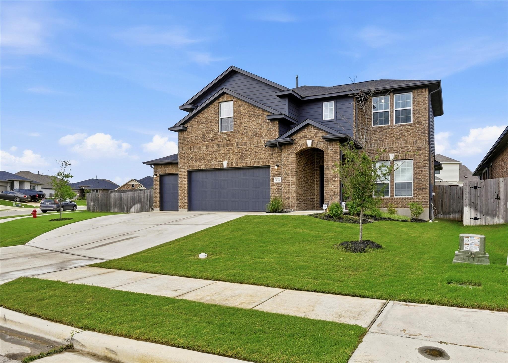 A classic brick facade with modern dark siding cr