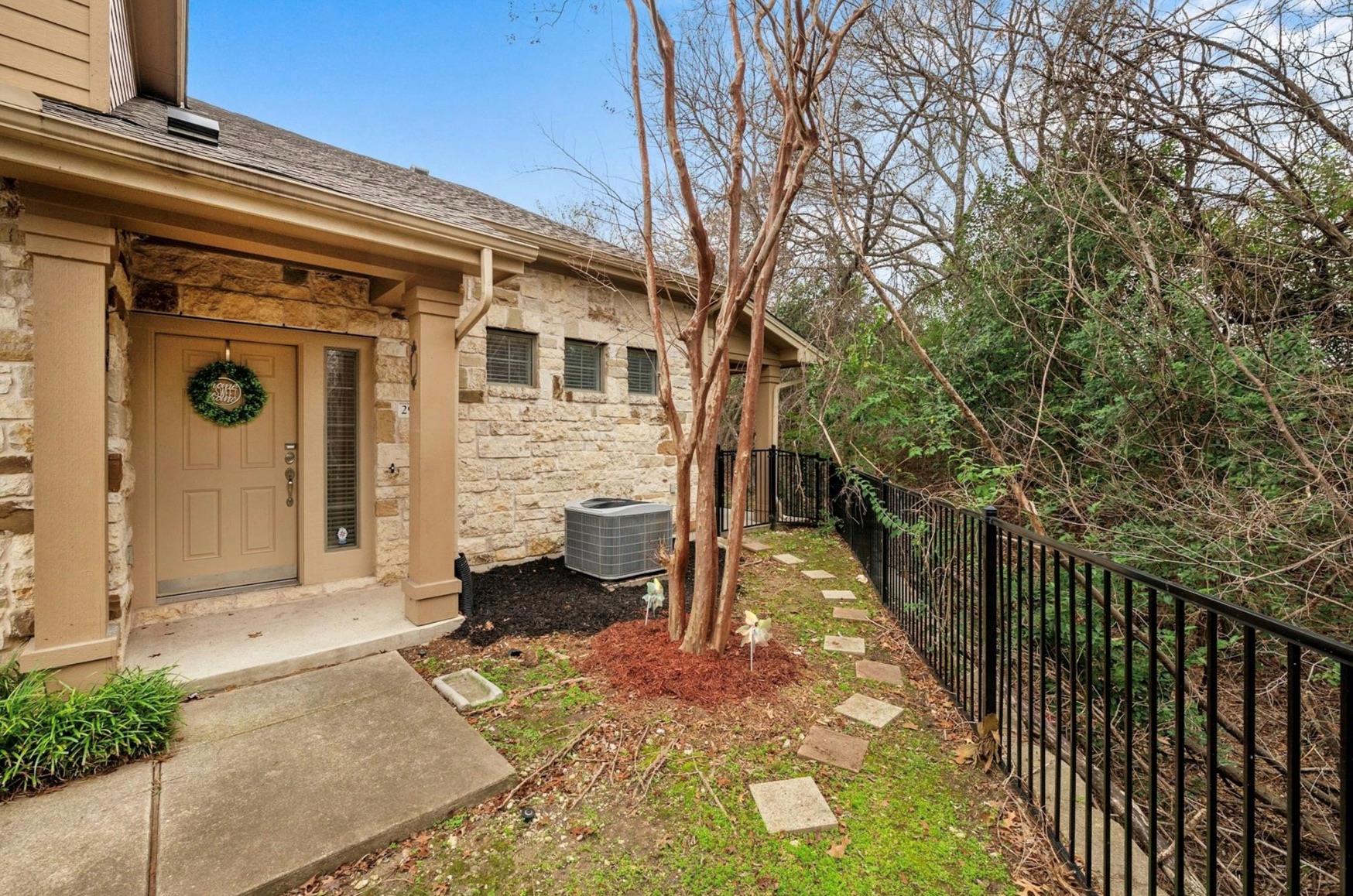 A stone-clad residence with an inviting entry, fr