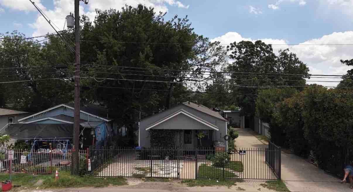 A quaint residence featuring a gated front yard, 