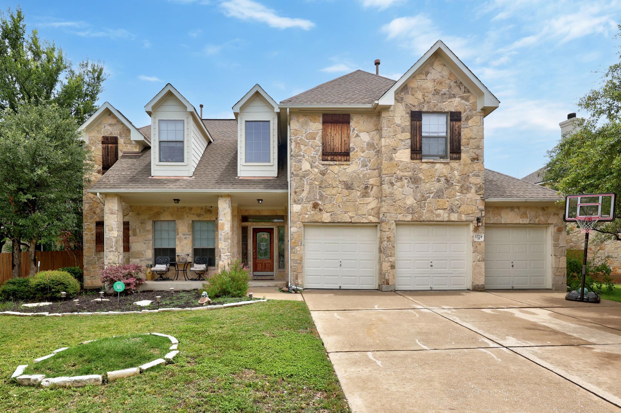 A spacious stone-clad residence with an inviting 