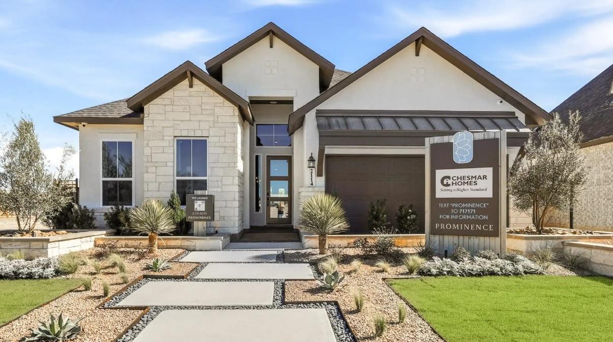 A striking modern stucco and stone exterior welco