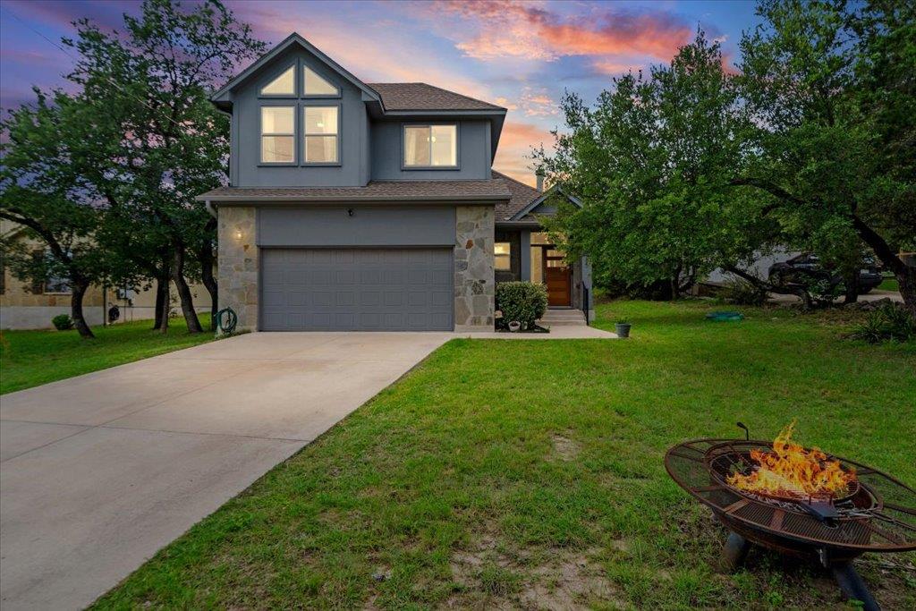 A well-maintained residence featuring a stone fac