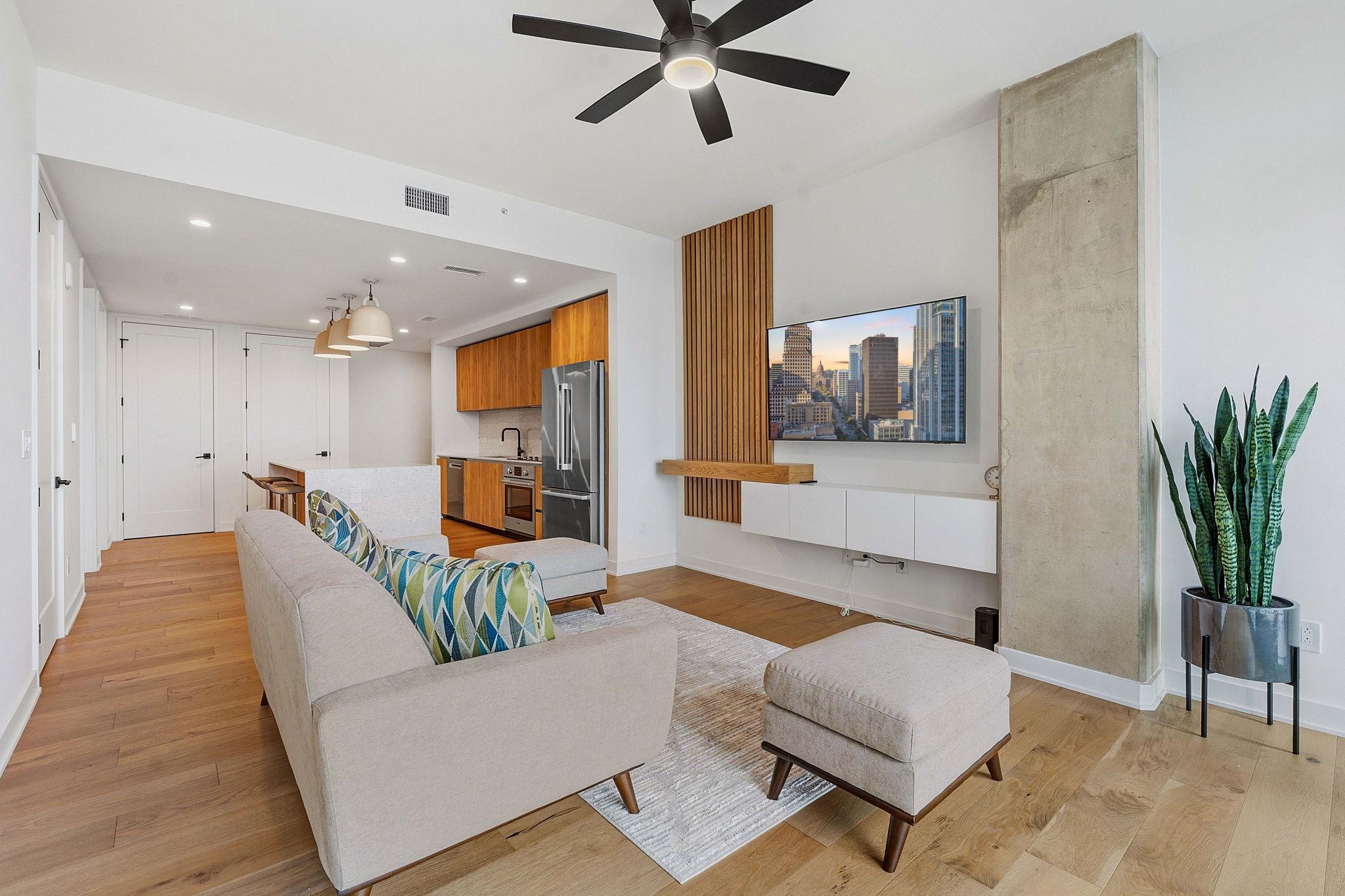 An open-concept living area boasts a sleek entert