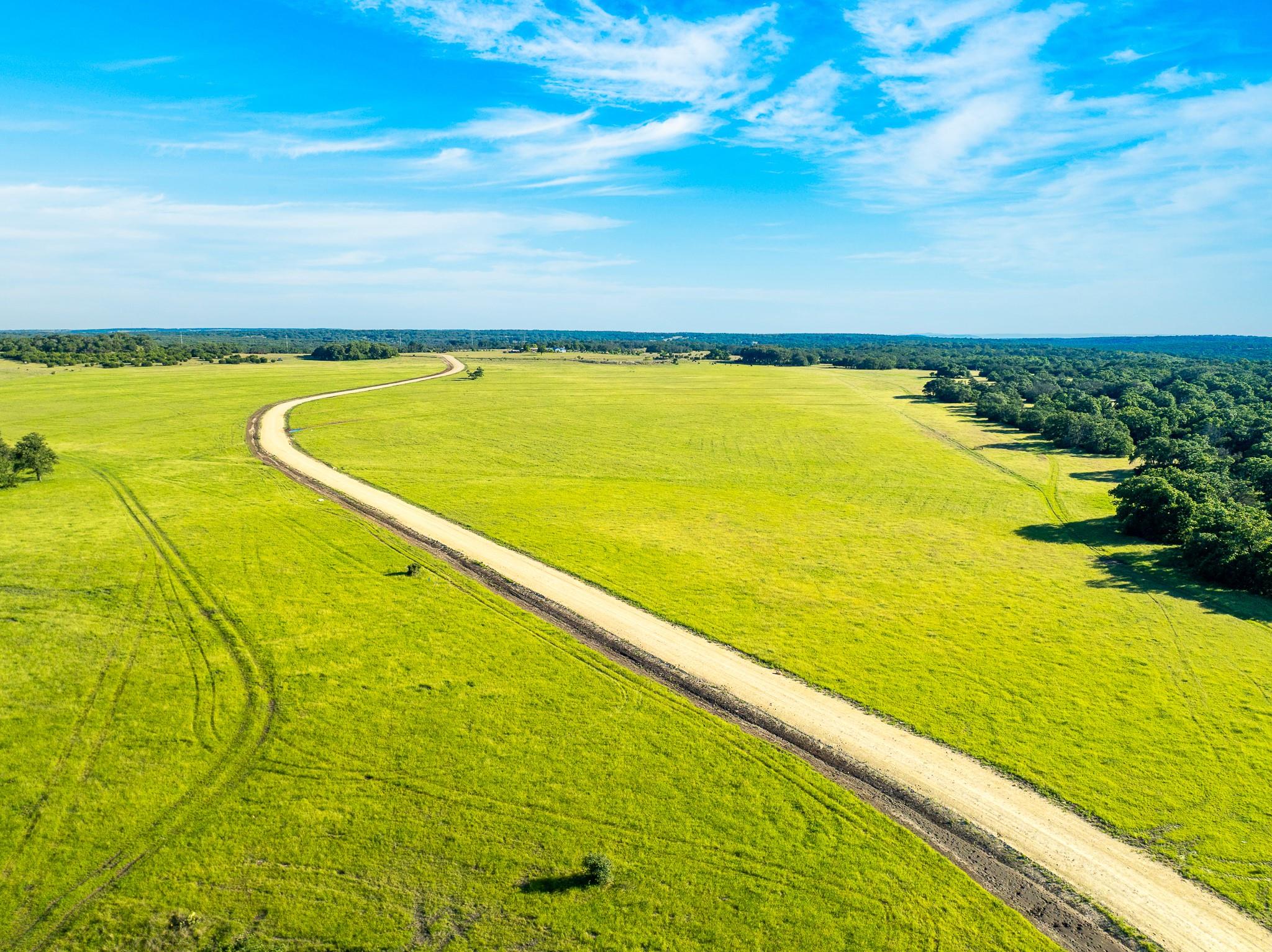 Acres of verdant pastureland unfold beneath an op