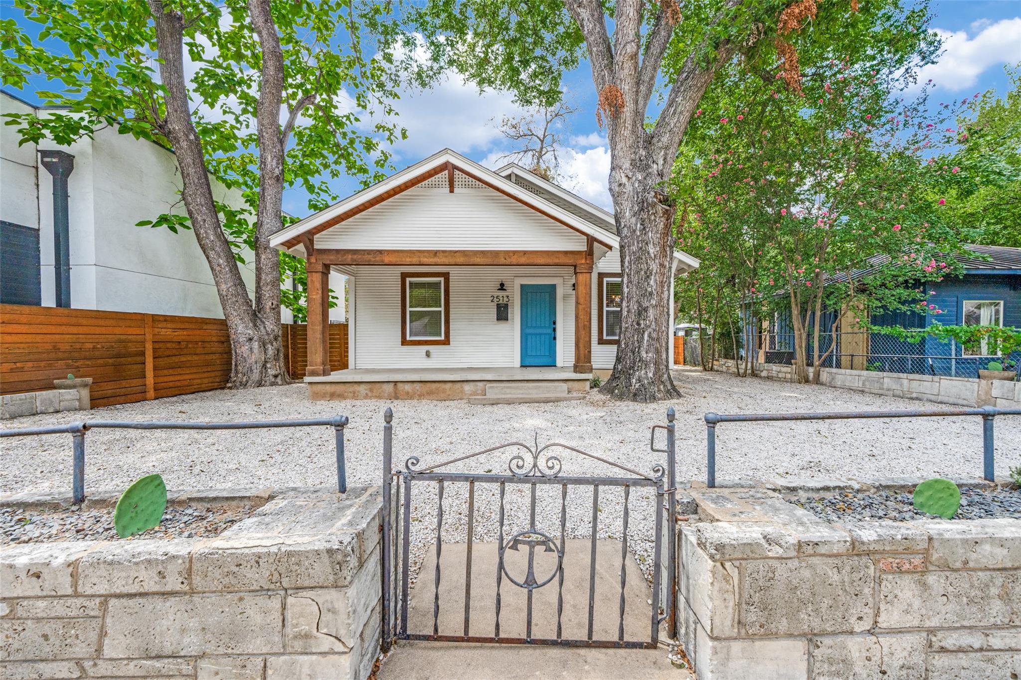 A charming bungalow with a welcoming porch and a 