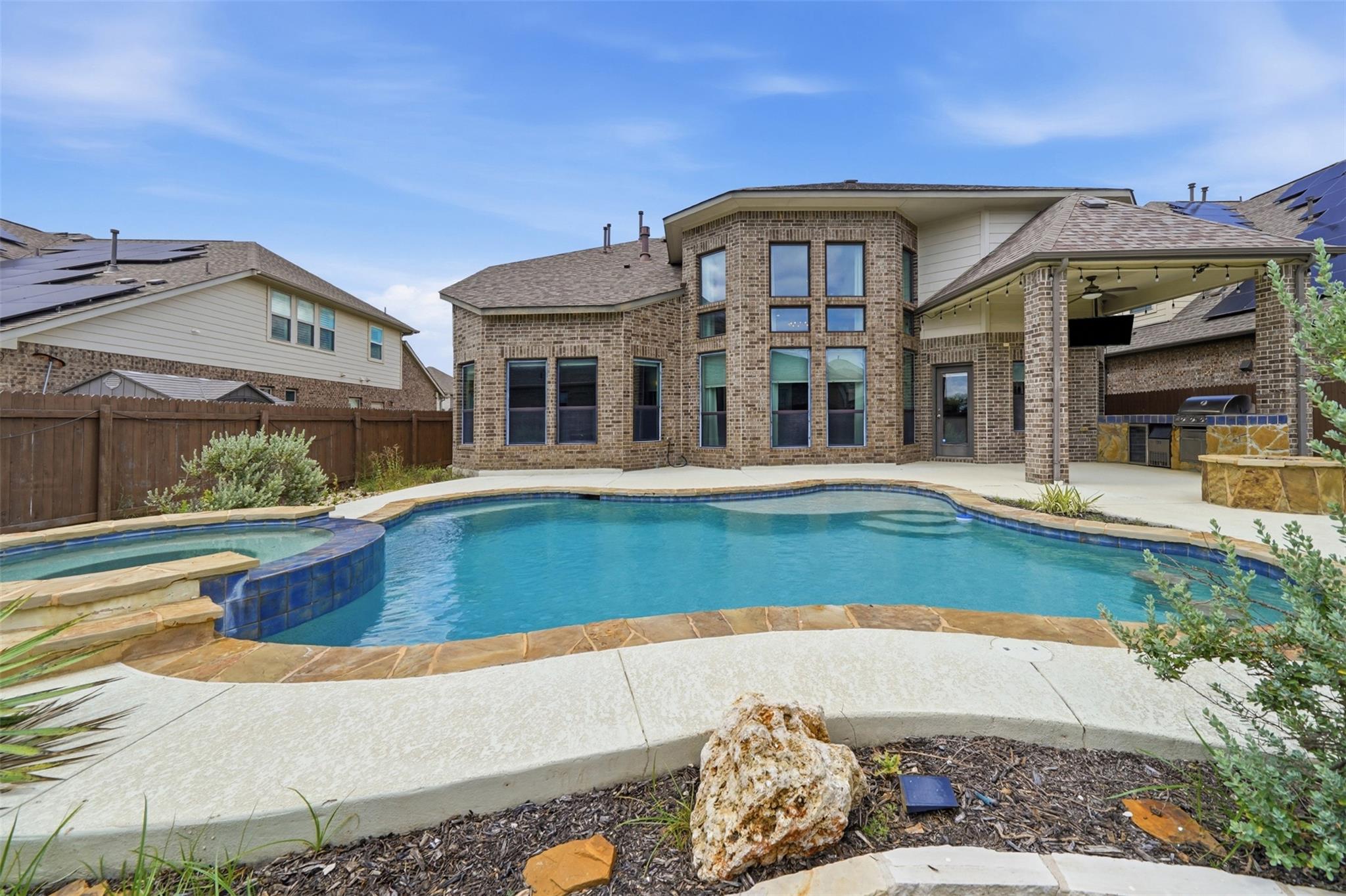 An inviting backyard oasis offers a sparkling poo
