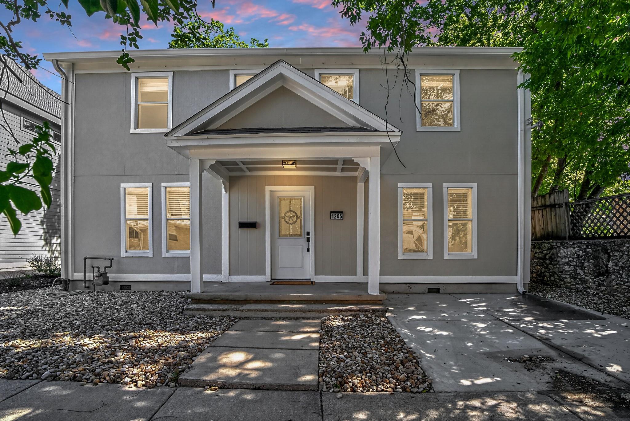A welcoming covered entry portico invites residen