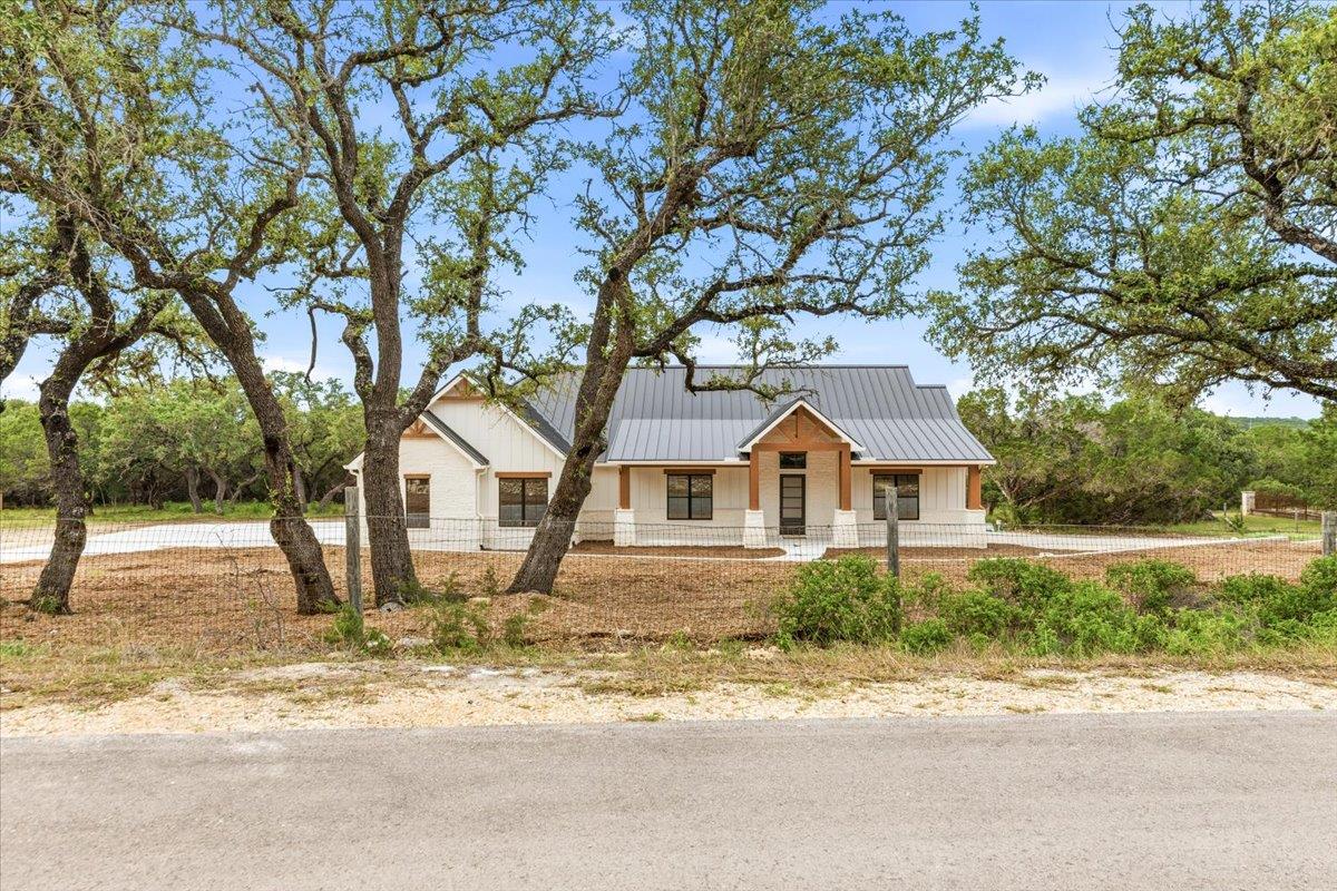 A newly constructed modern farmhouse with a durab