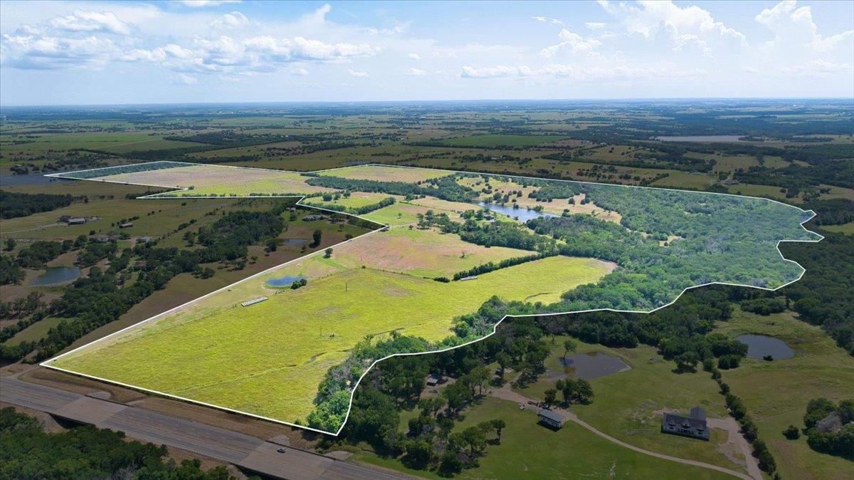 Acres of verdant land unfold, featuring multiple 