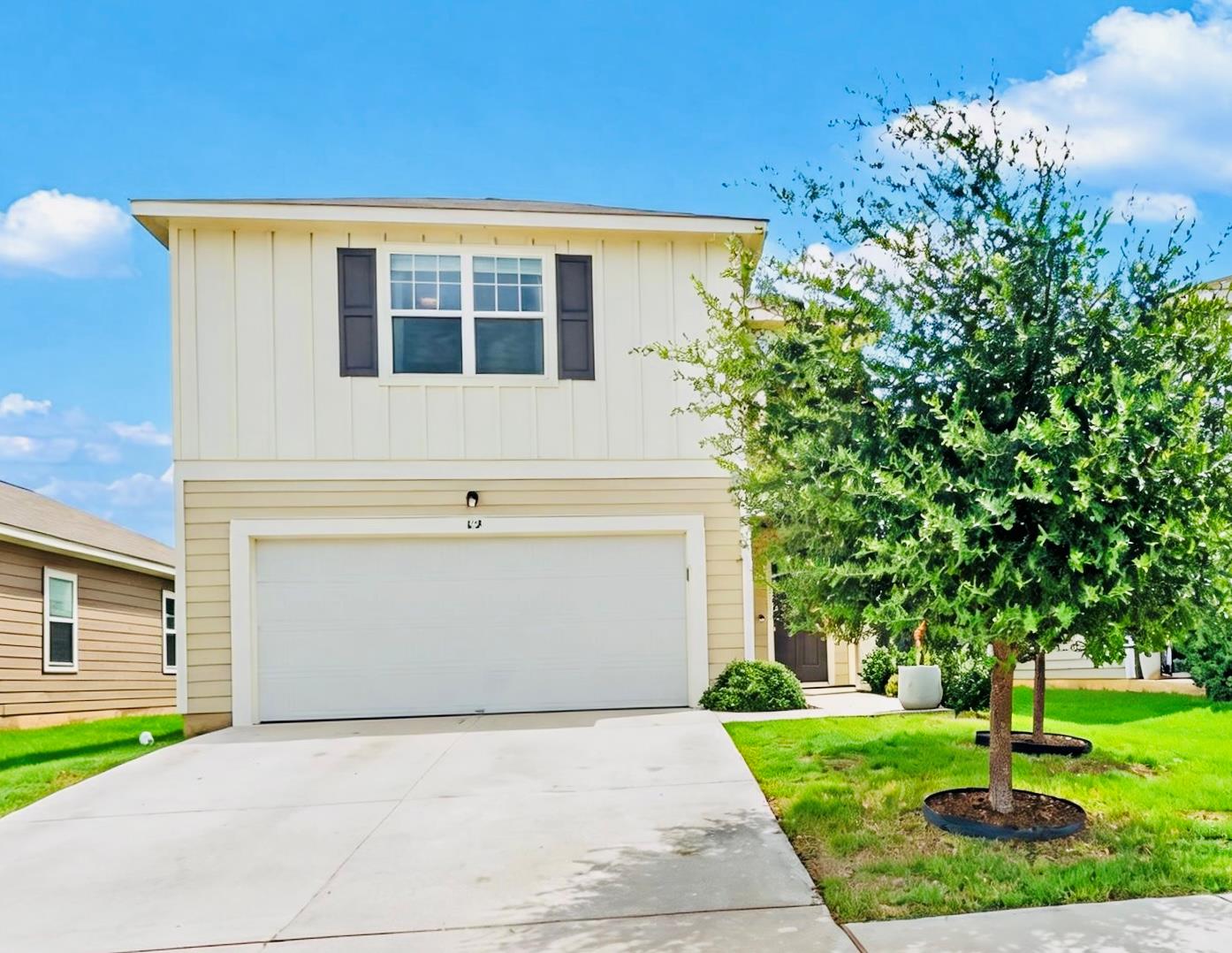 A well-maintained facade with a two-car garage an
