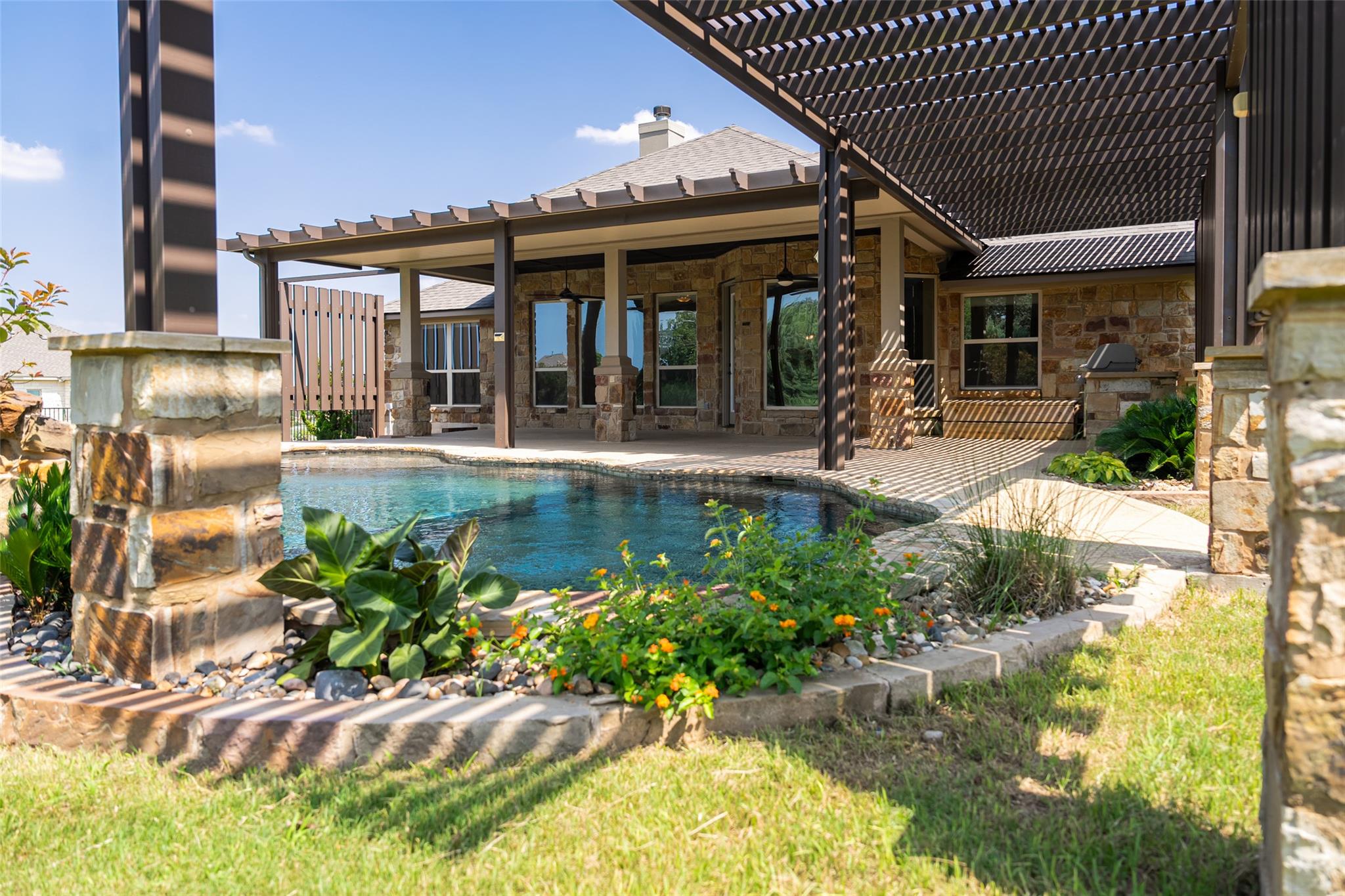 An inviting backyard oasis offers a sparkling poo