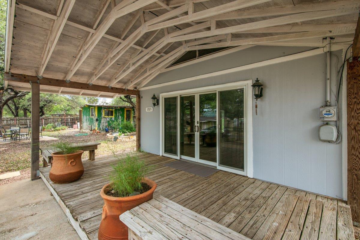 An inviting wooden deck extends a welcoming outdo