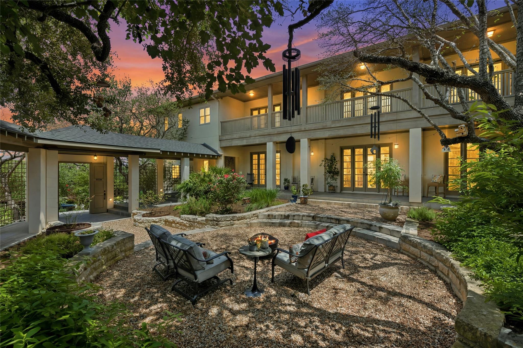 An inviting backyard oasis features a fire pit, g