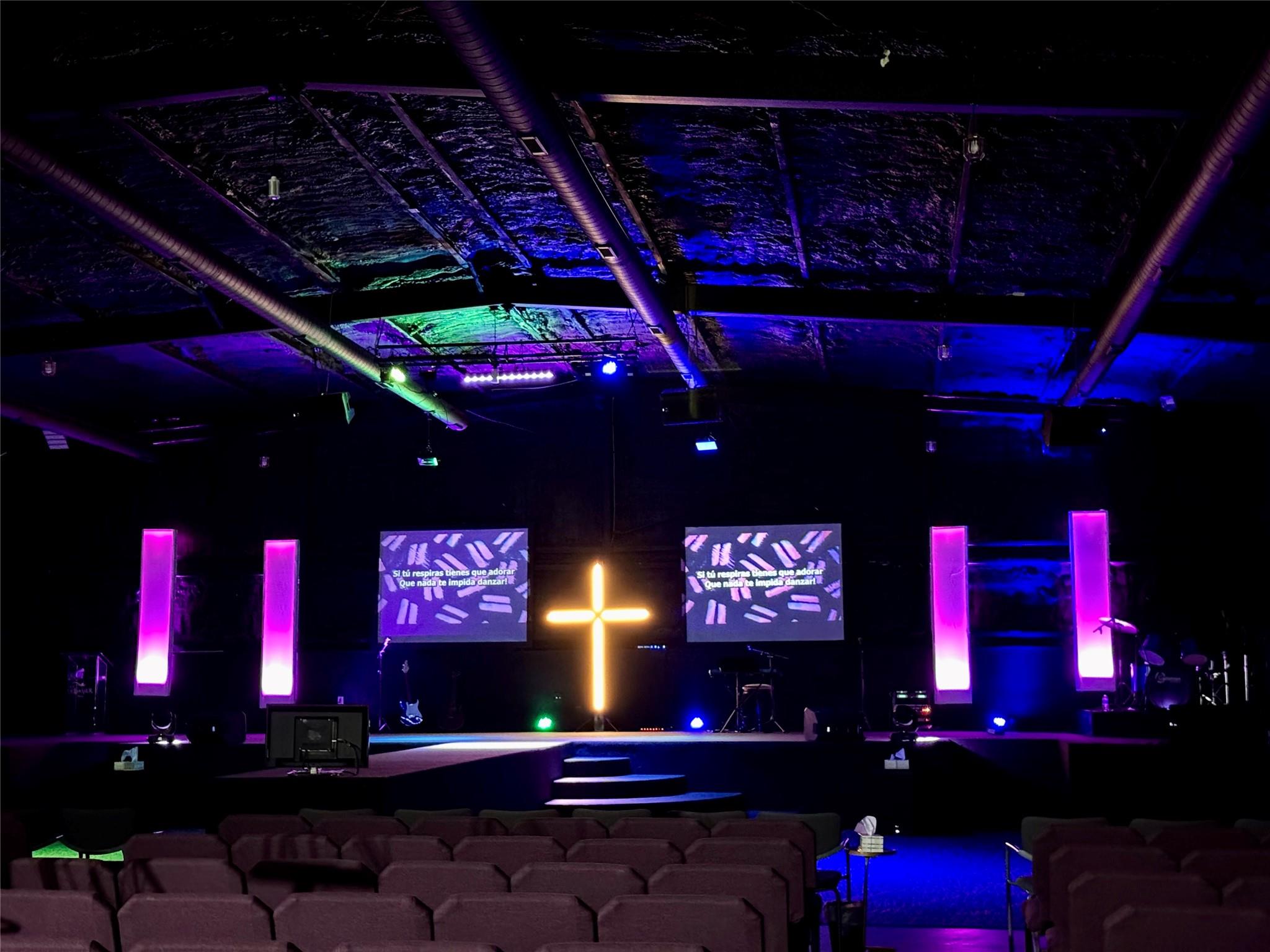 The spacious worship hall features stage lighting