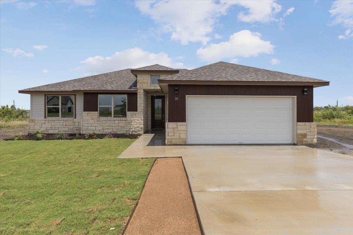 Modern single-story residence with a stone and wo