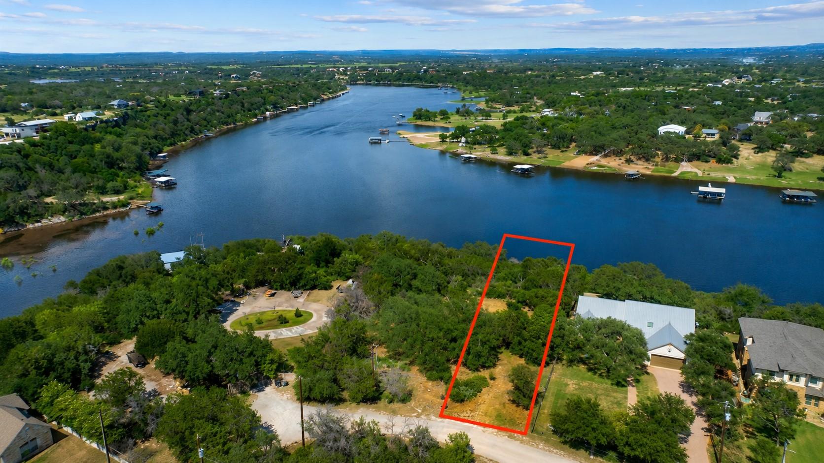 A prime waterfront lot, nestled among lush trees,