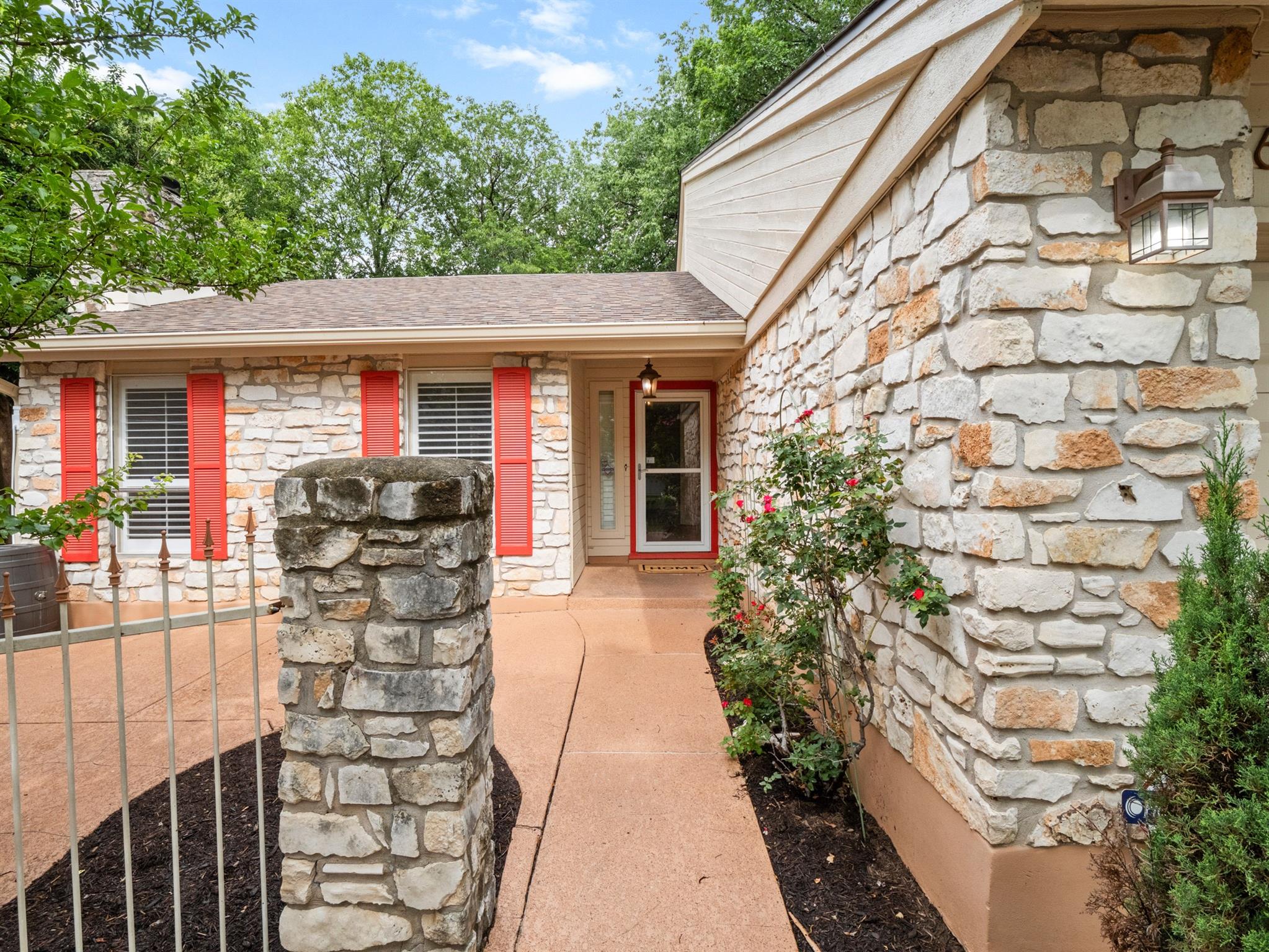 A stone facade welcomes you home with vibrant red