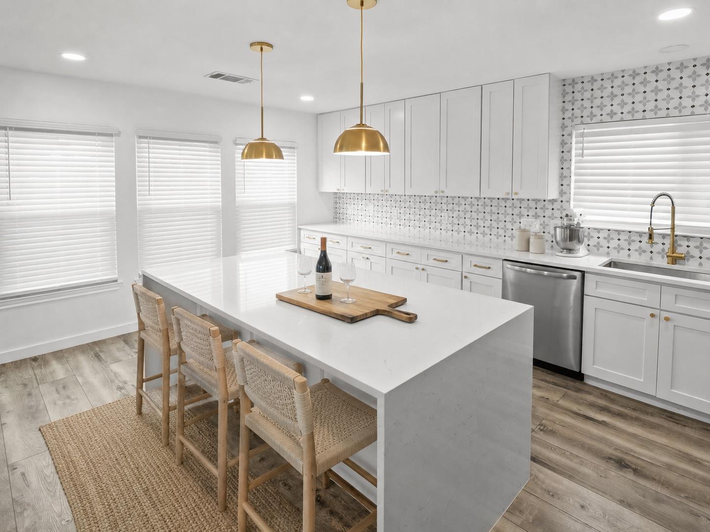 A pristine kitchen offers a large island with sea
