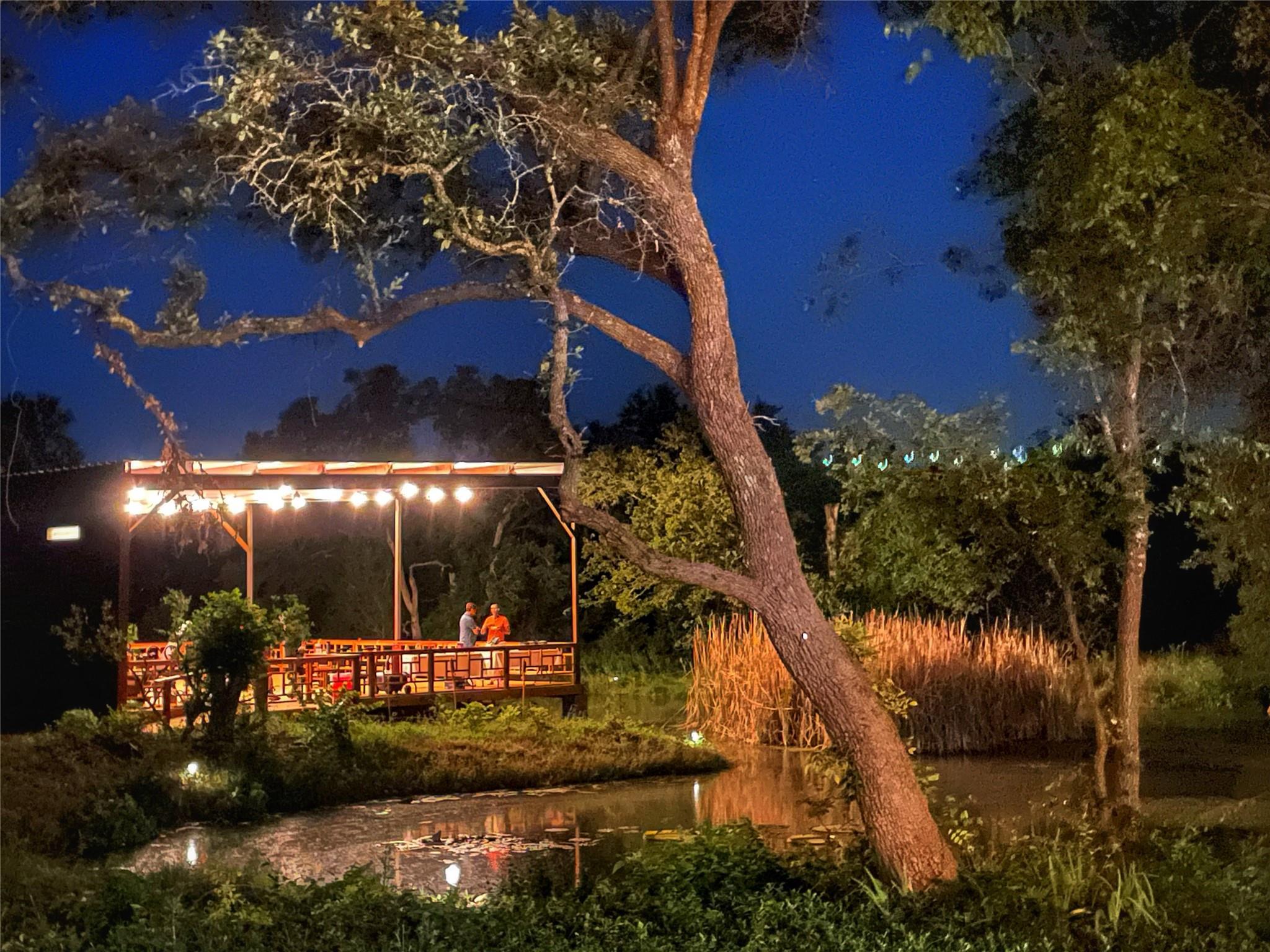 An illuminated lakeside deck creates an idyllic e