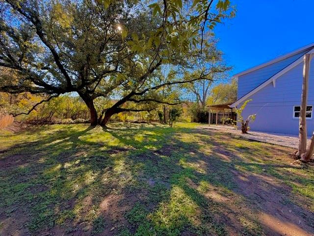 Mature trees and a lush lawn create a serene sett