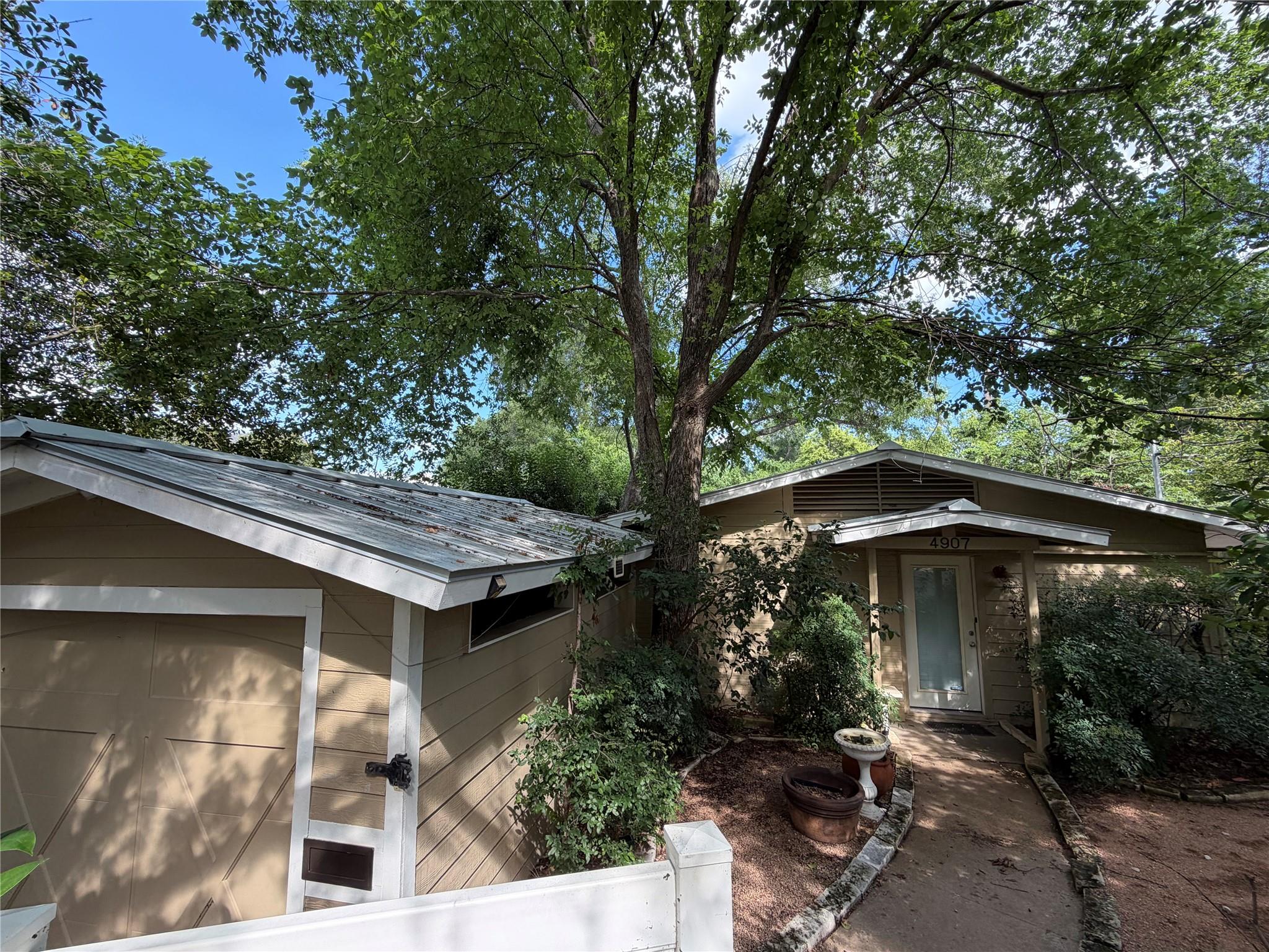 A private, tree-shaded residence welcomes with a 
