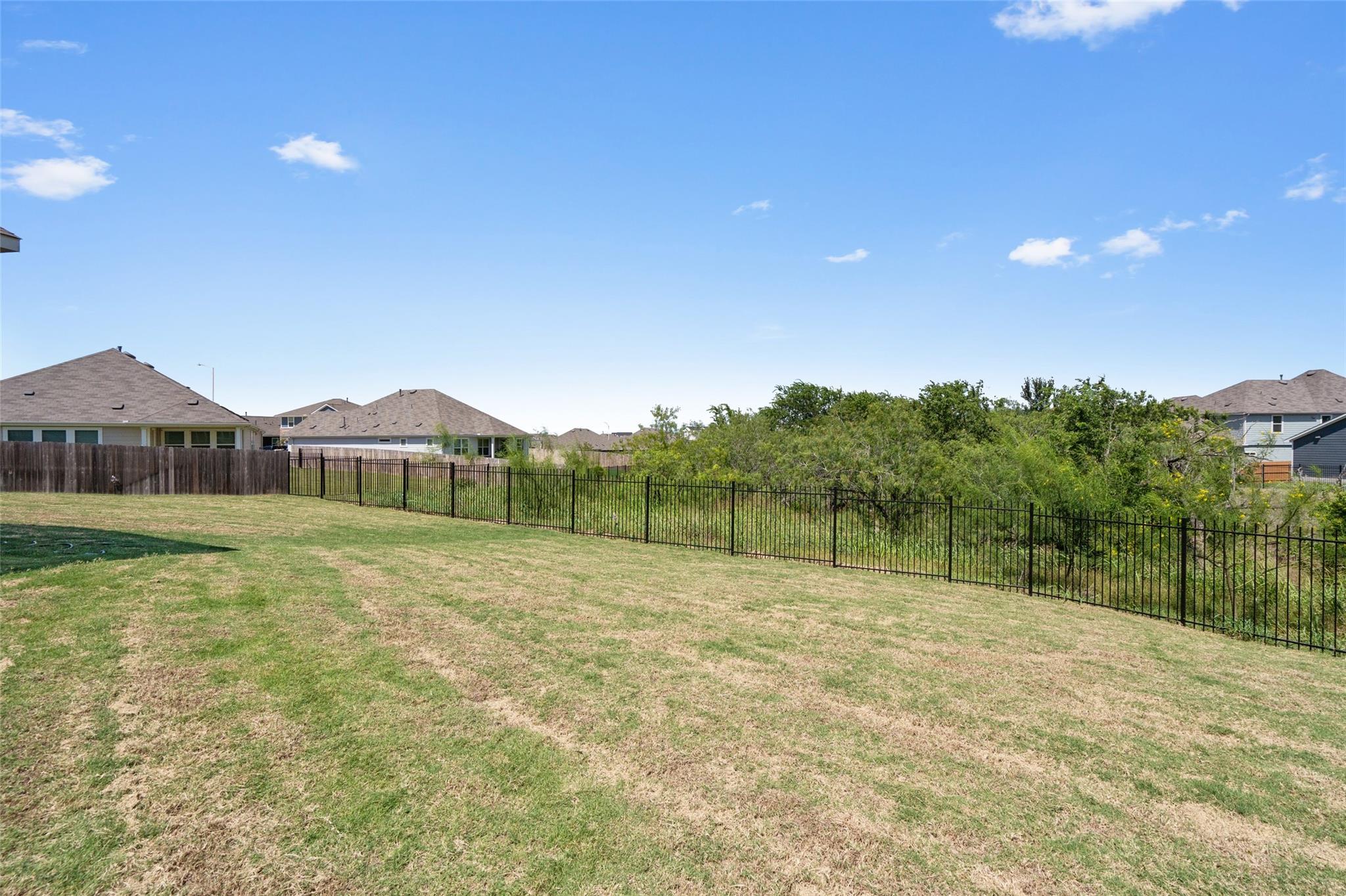 A spacious, open yard offers ample room for outdo