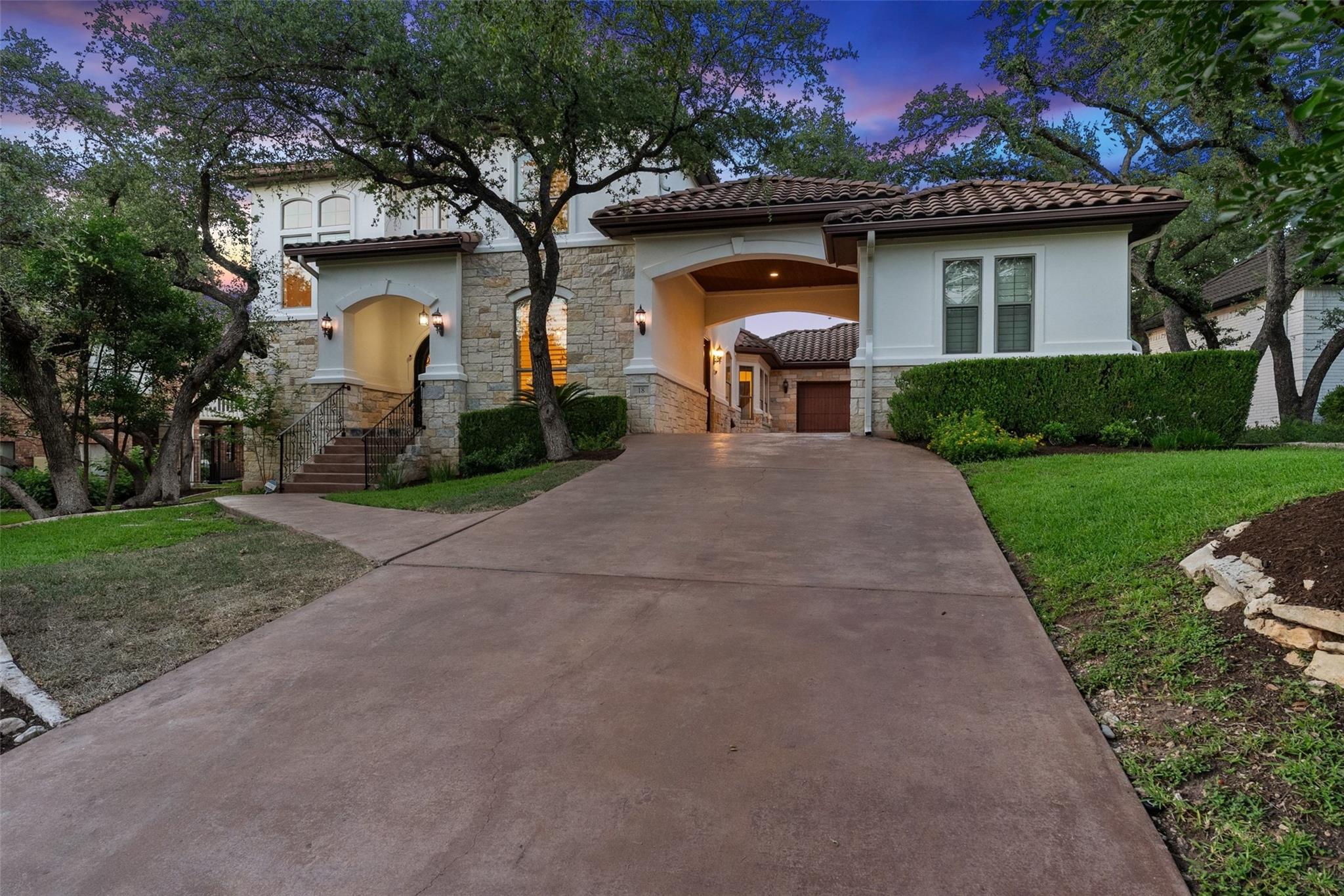 Elegant driveway approaches a grand home with str
