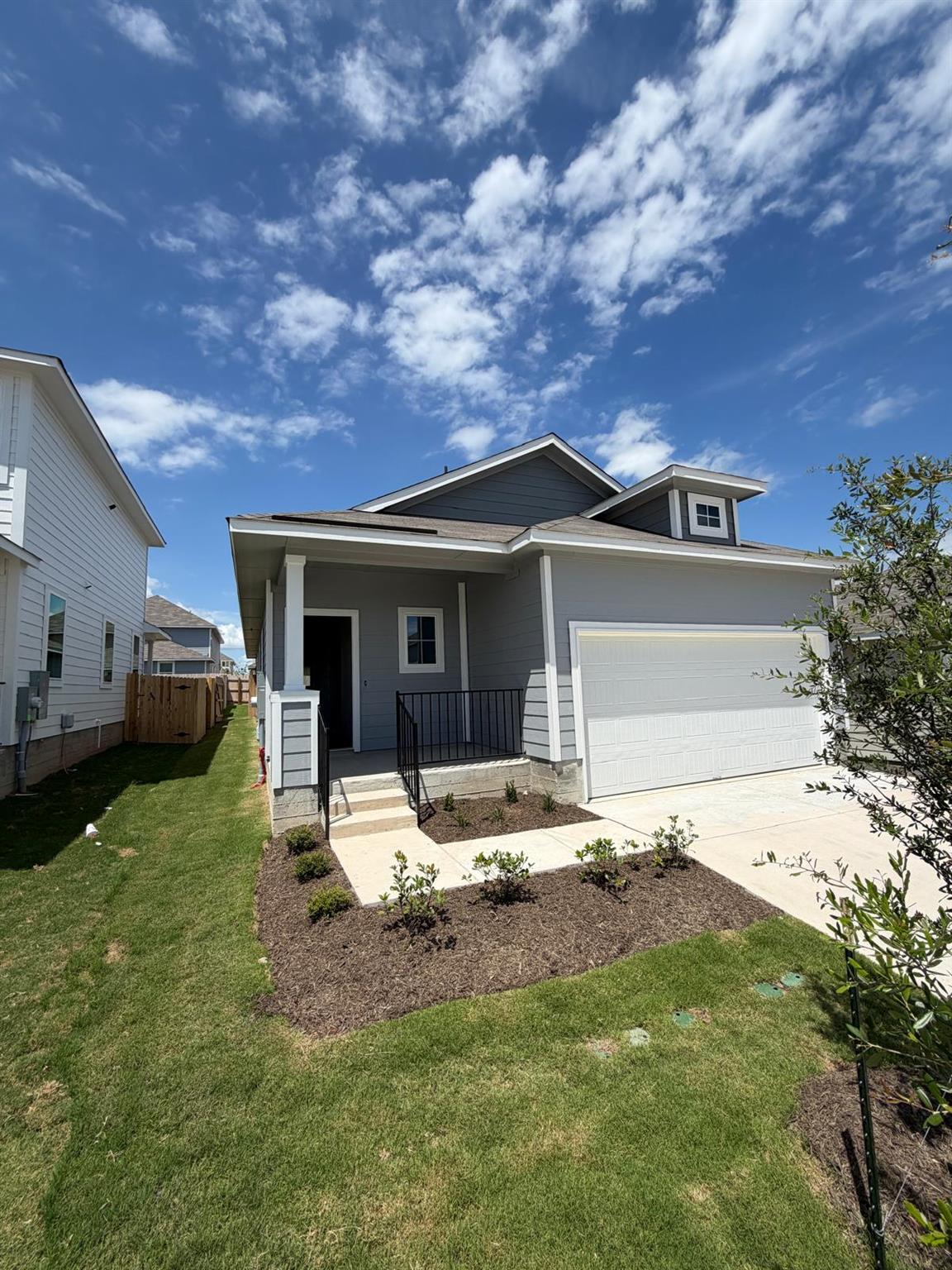 A neatly manicured lawn and tidy landscaping crea