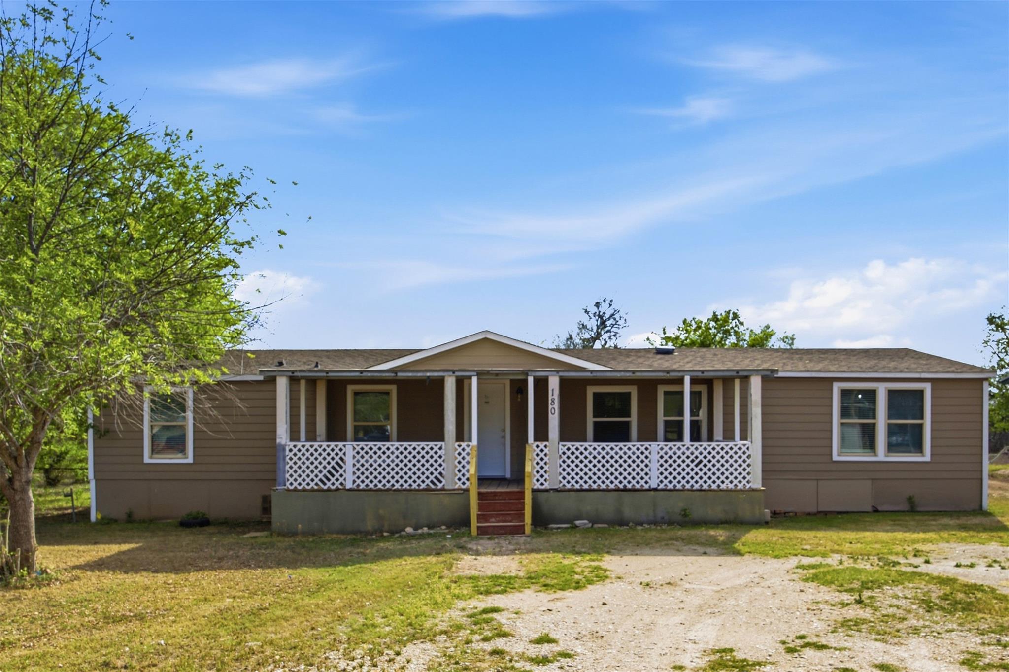 A spacious covered front porch spans the entrance