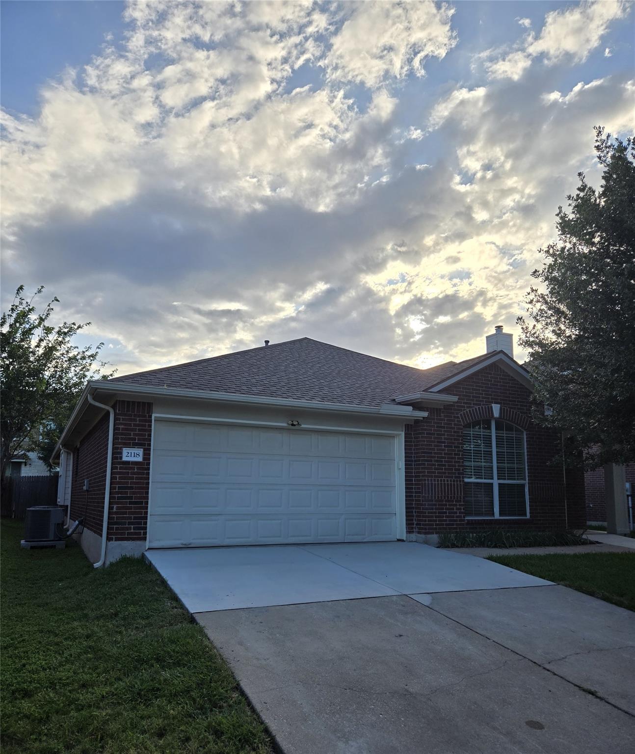 A classic brick exterior with a two-car garage aw