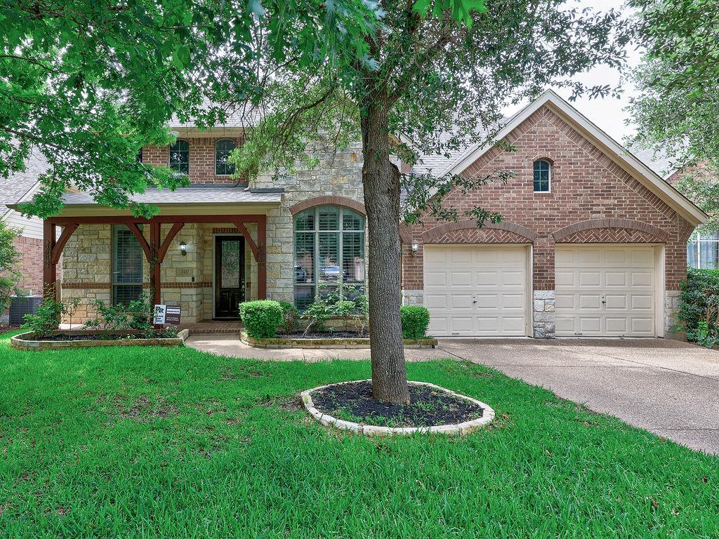 A stone and brick facade with a welcoming porch d