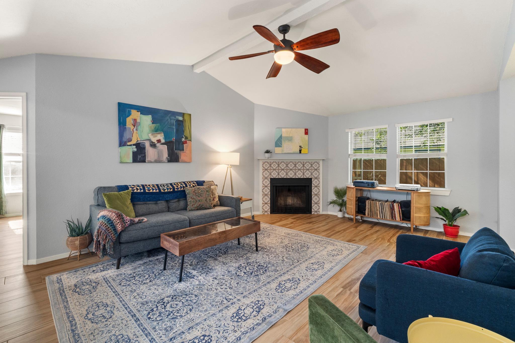 A vibrant living area with vaulted ceilings featu