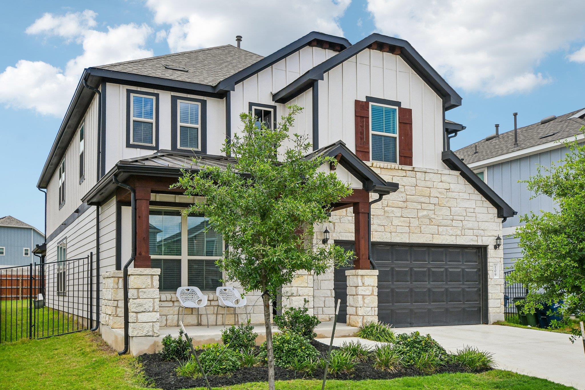 A striking modern facade with stone and siding ac