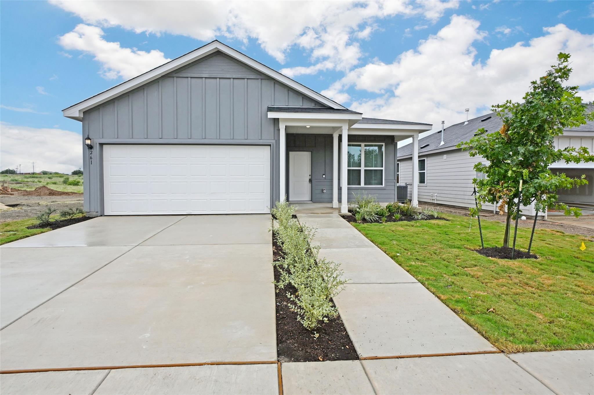A newly built home features a welcoming front ent