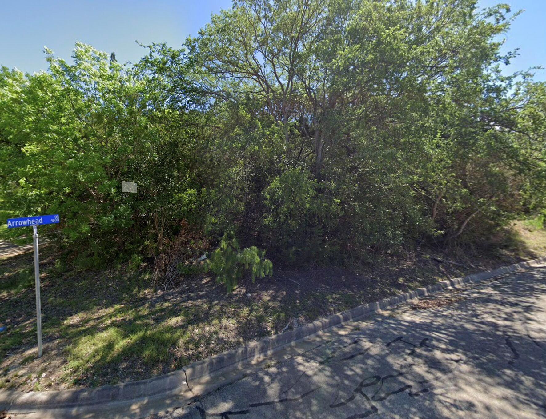 A corner lot with mature trees offers a promising