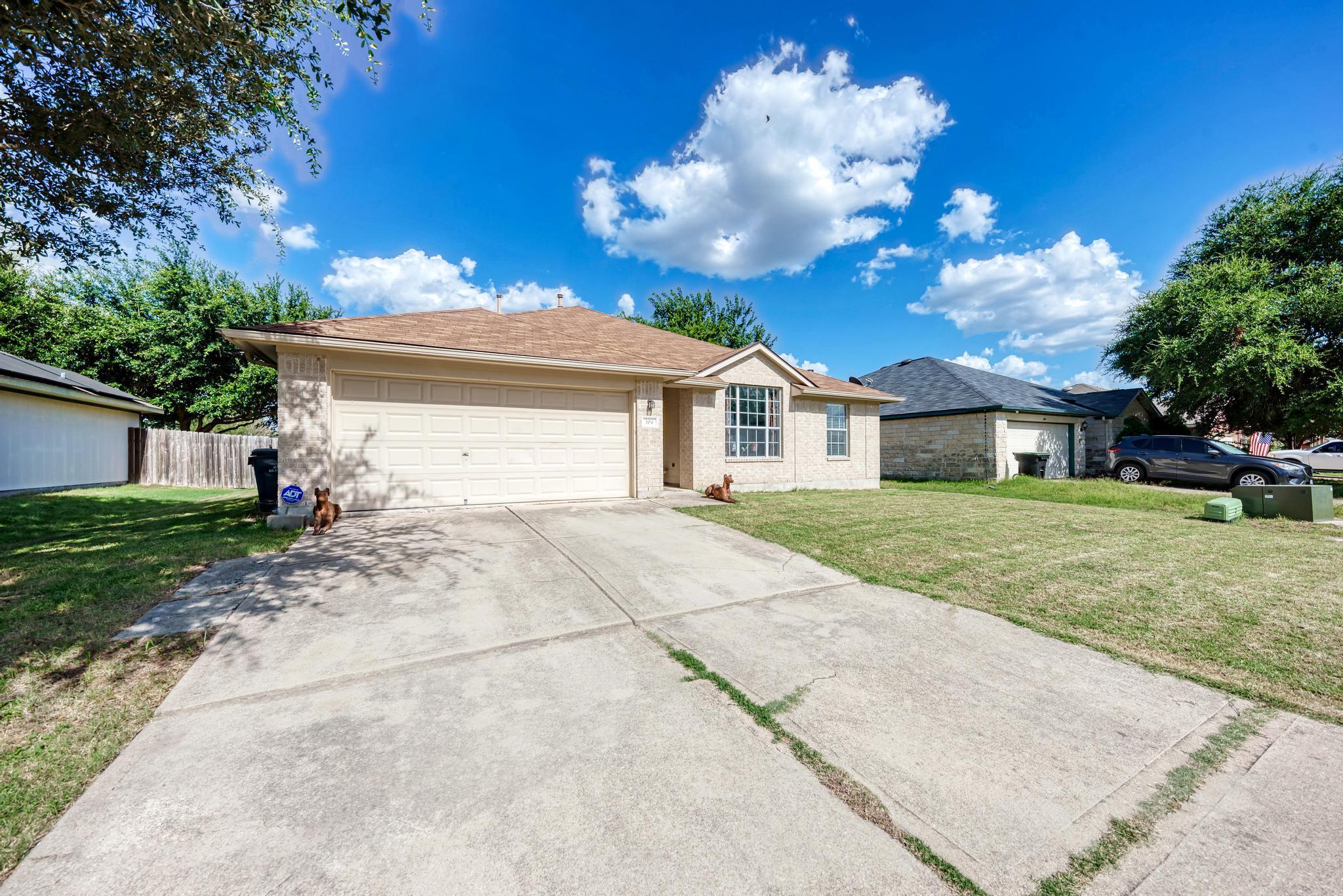 A classic brick exterior with a welcoming drivewa