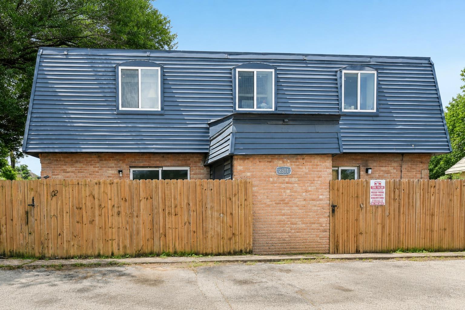 A well-maintained brick and siding facade with a 