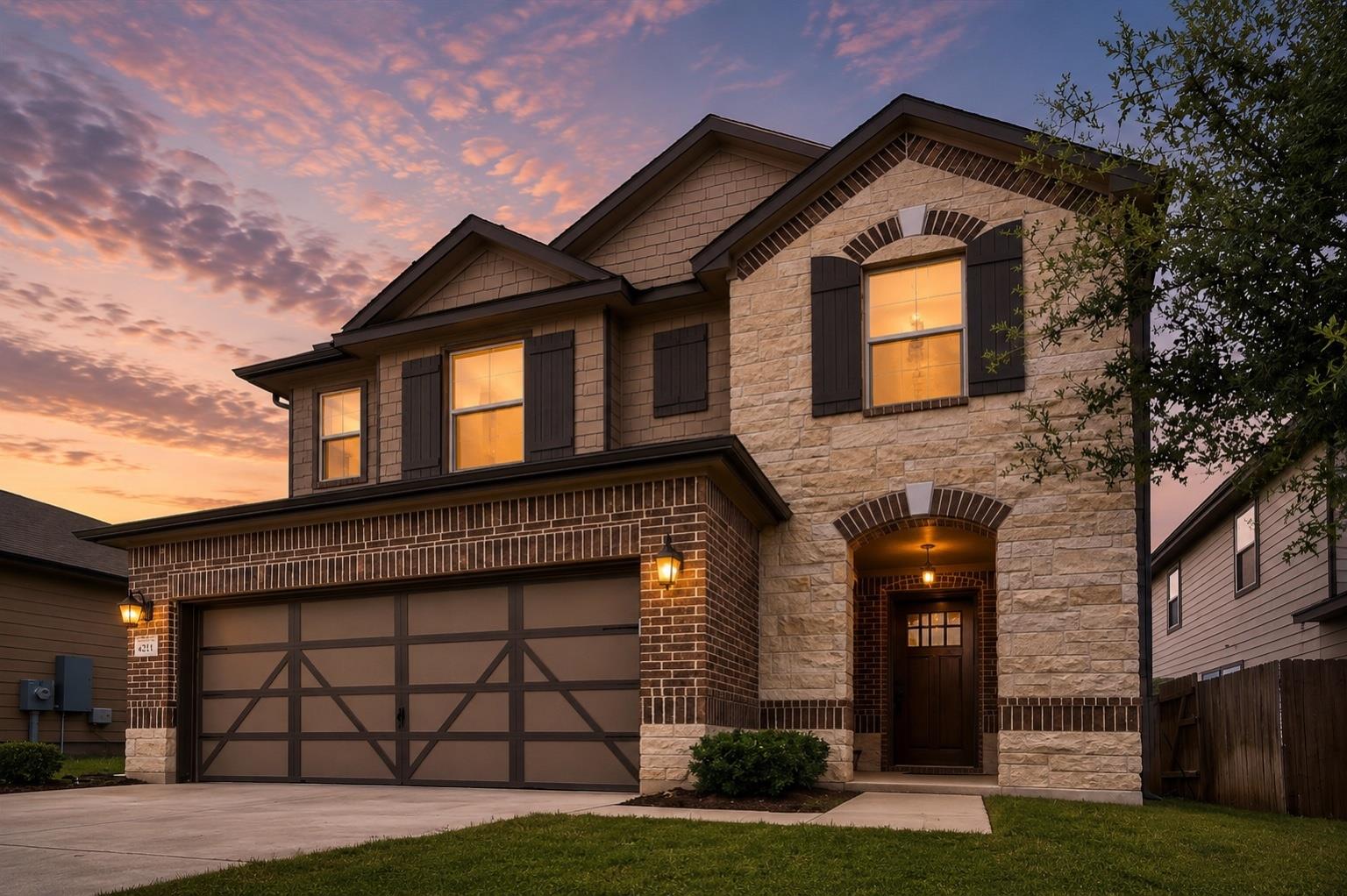 A striking exterior combines brick, stone, and si