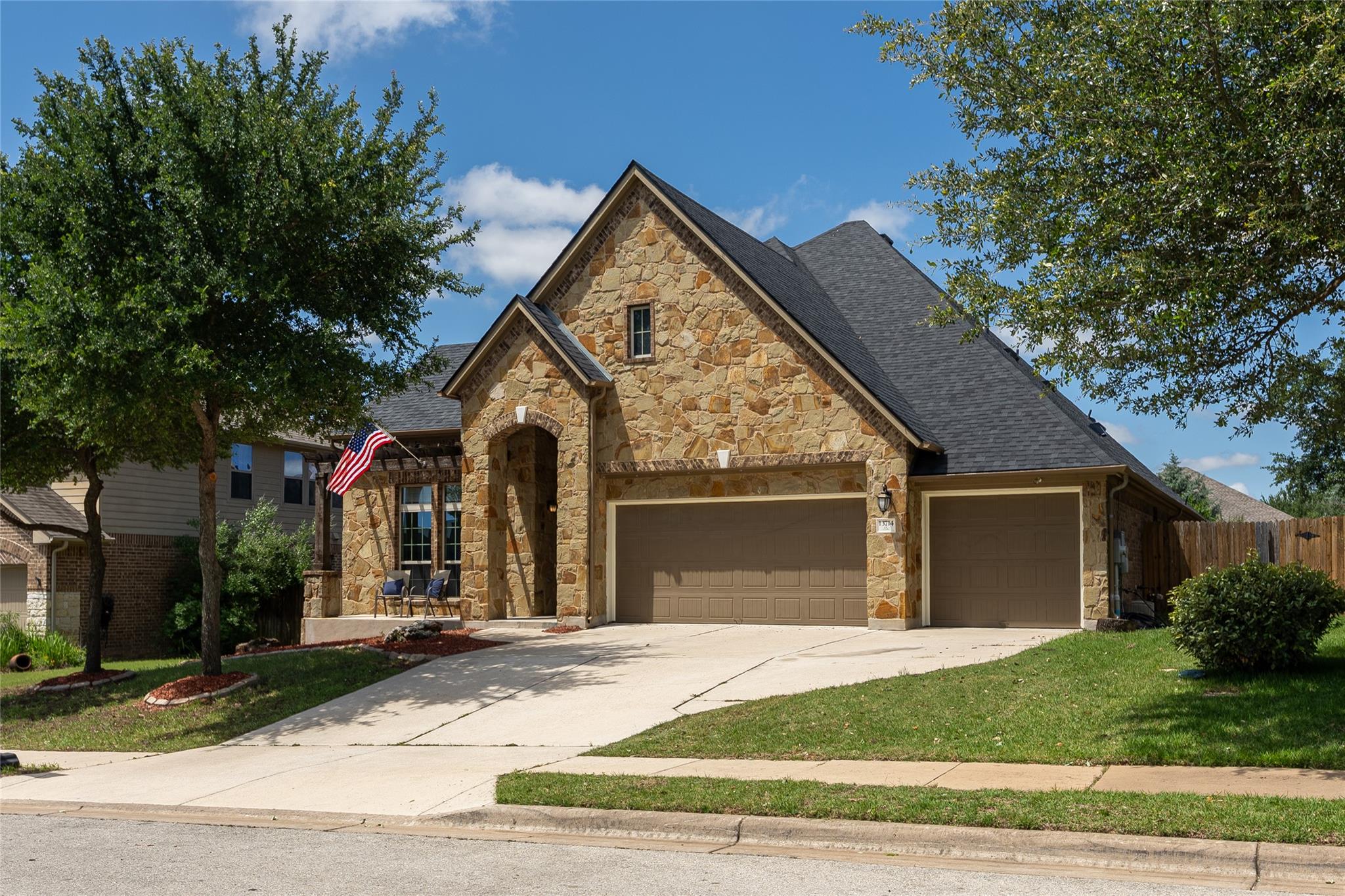 A classic stone facade with an arched entry welco