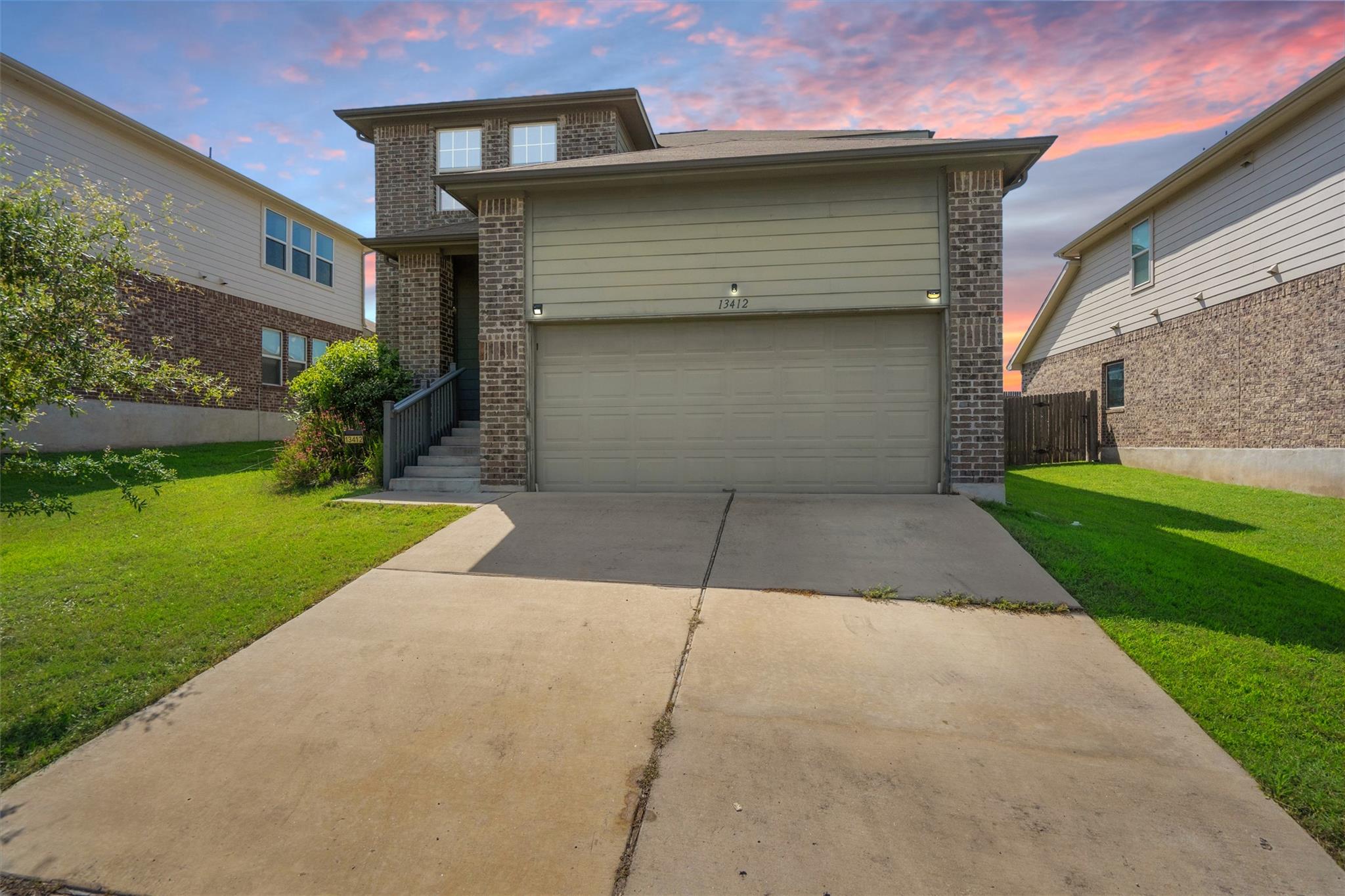 A classic brick and siding home with an attached 