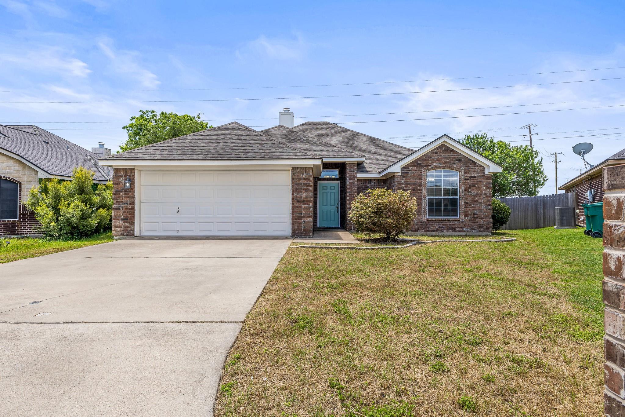 A classic brick exterior and a bright blue entry 