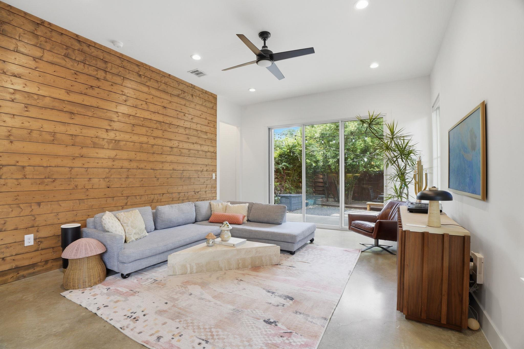 A striking wood-paneled accent wall elevates this