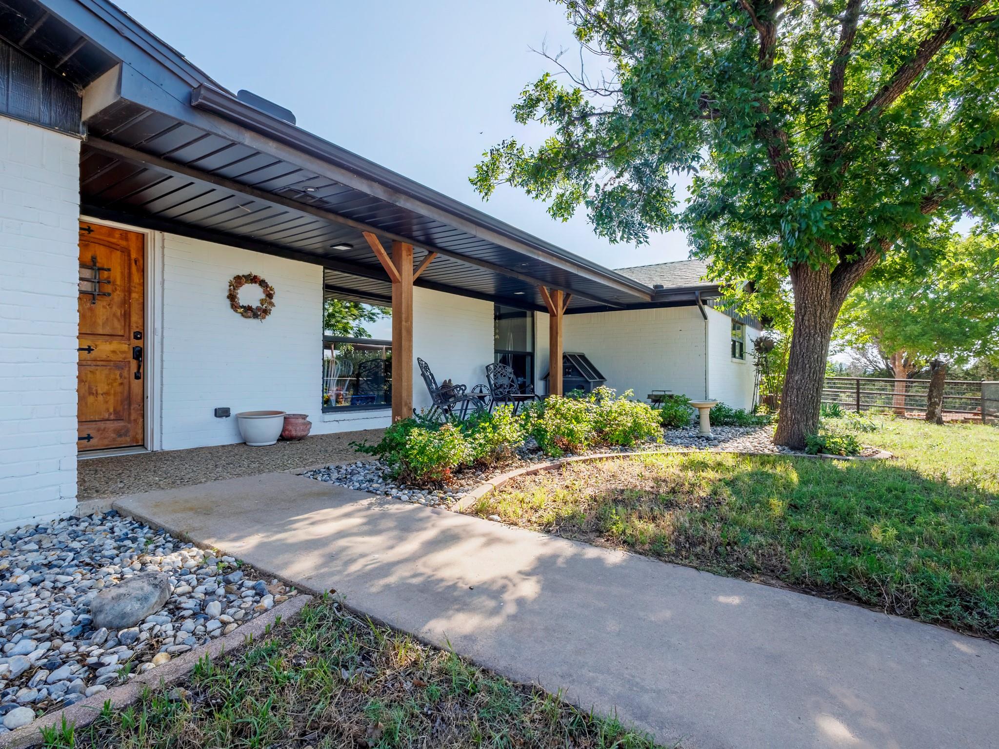 A welcoming front entry with a carved wood door a